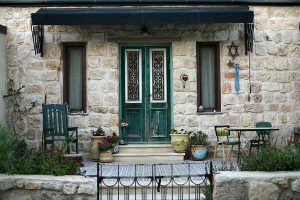 Stone Home with Green Door and Awning