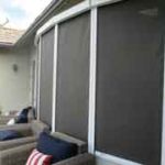 Sun Shades on a back patio with Wicker Furniture