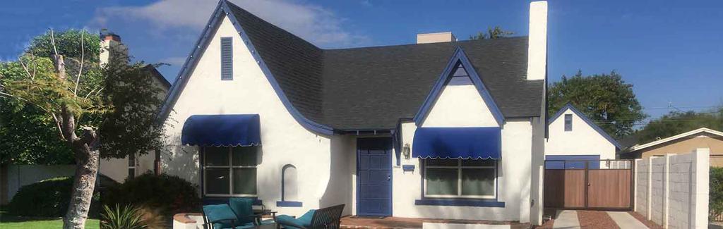 White House with Royal Blue Awning over Windows and Doors