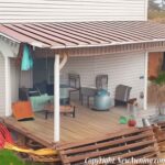 flood damaged home on back patio with rusty metal awning