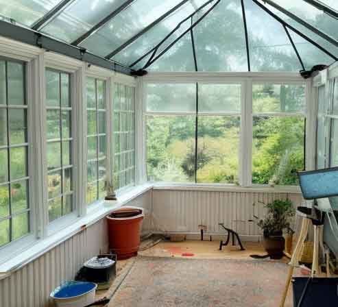 minimalist painter studio in a sunroom or screened patio